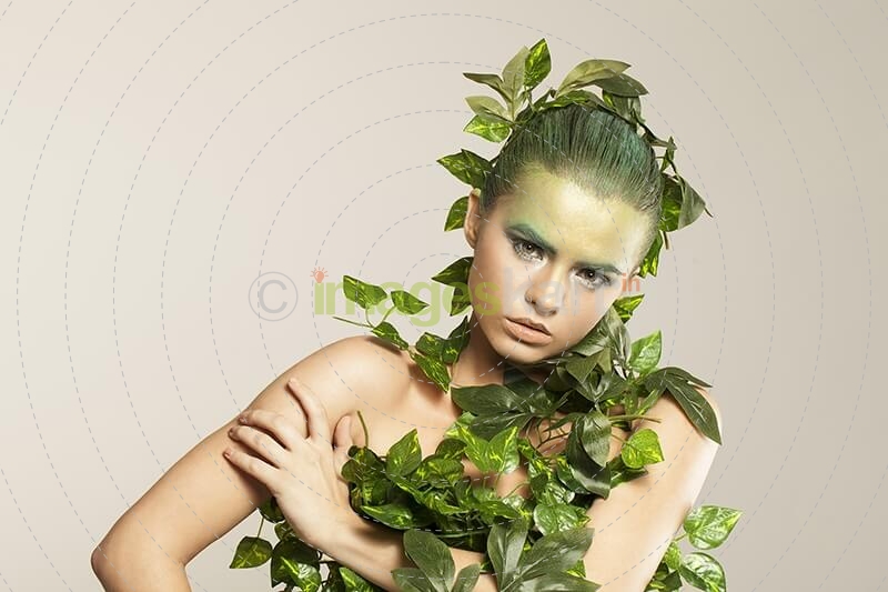 woman covered with green leaves