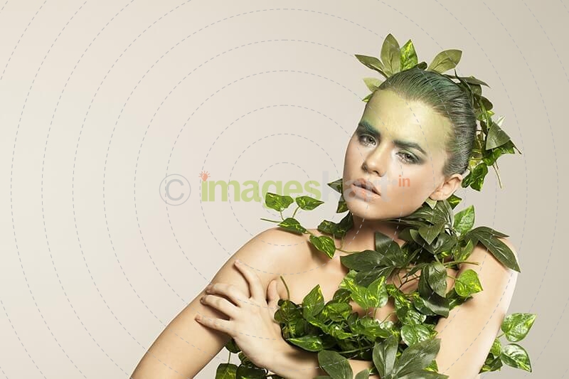 woman covered with green leaves