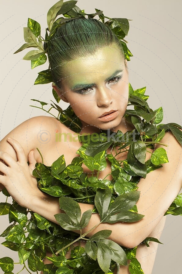woman covered with green leaves