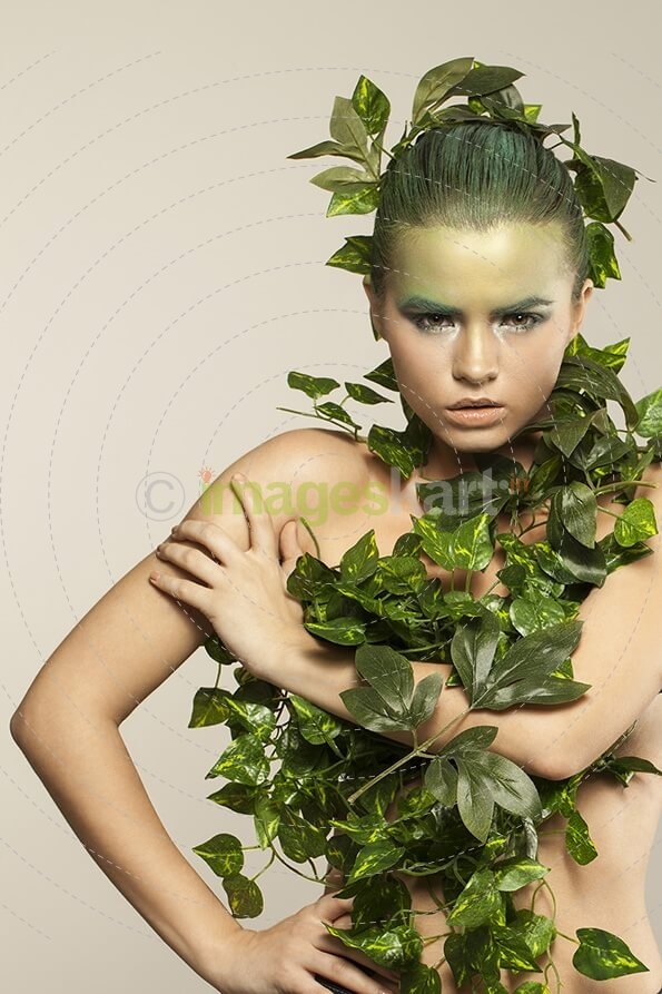 woman covered with green leaves