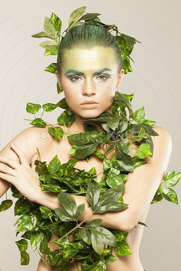 woman covered with green leaves
