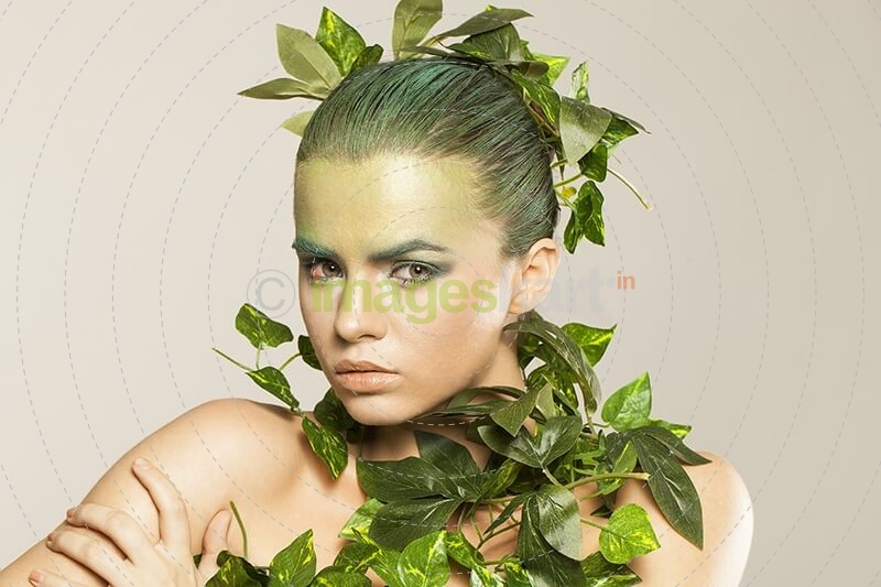 woman covered with green leaves