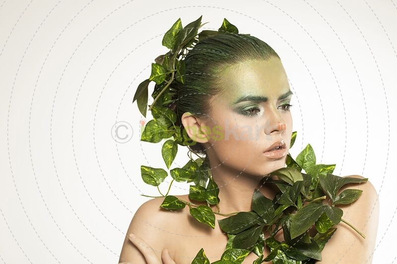 woman covered with green leaves