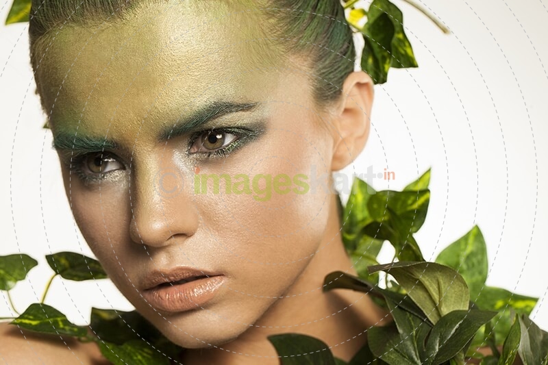 woman covered with green leaves