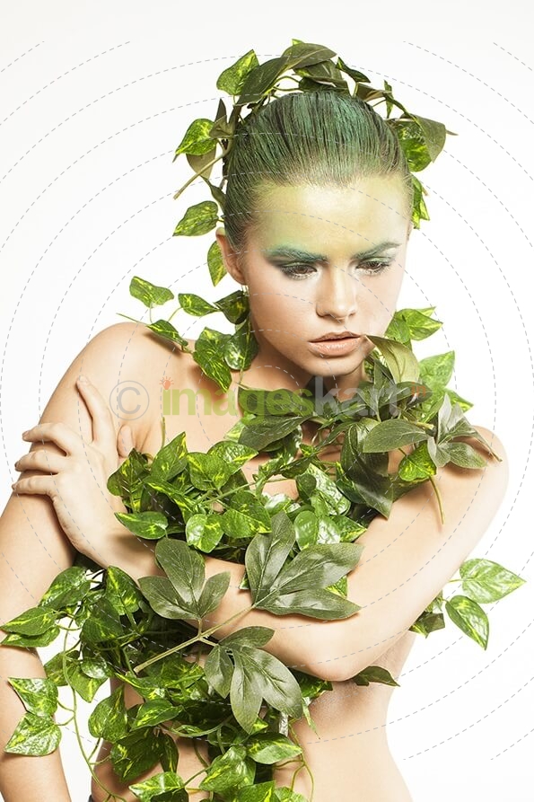 woman covered with green leaves