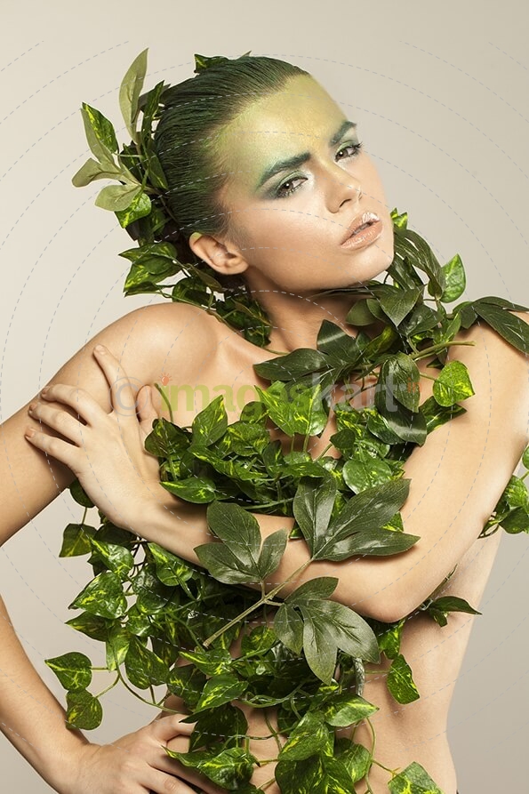 woman covered with green leaves