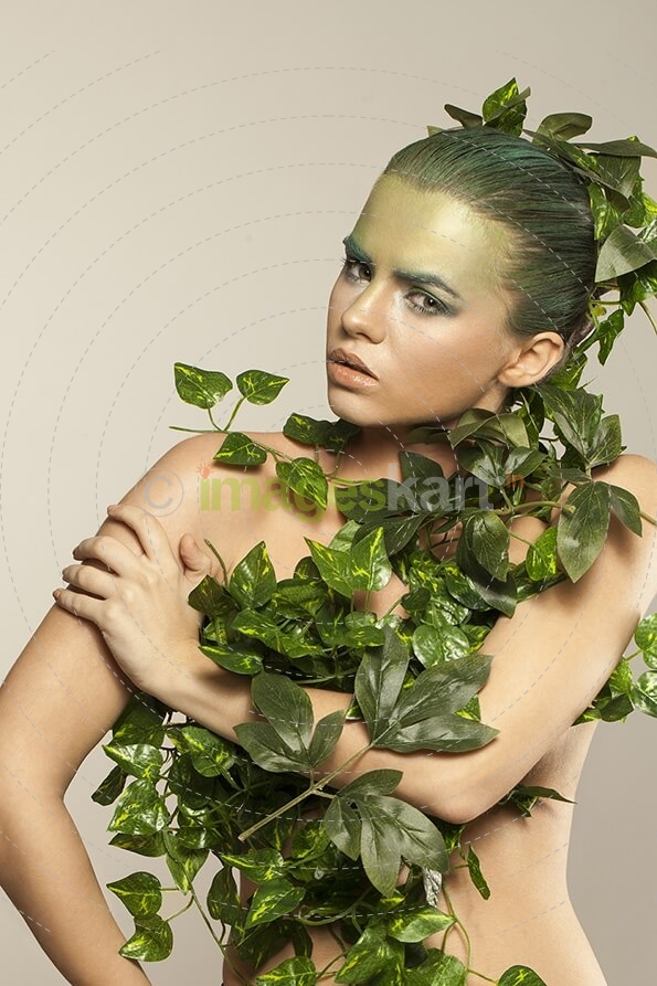 woman covered with green leaves