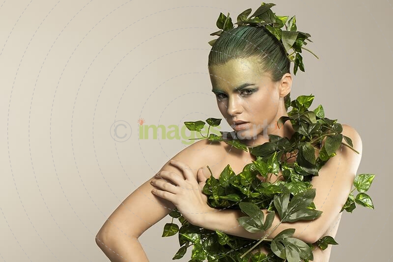 woman covered with green leaves