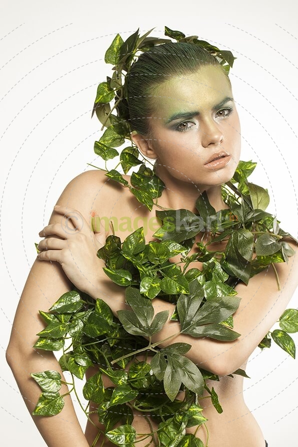 woman covered with green leaves