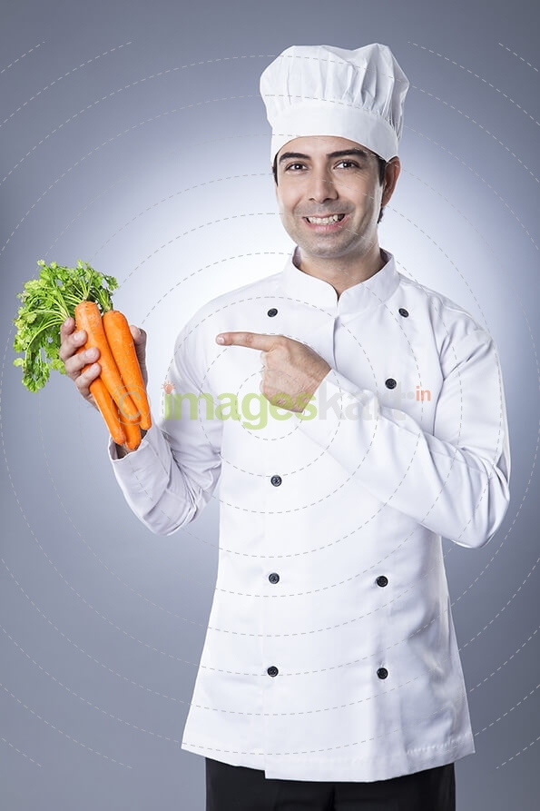 chef posing with fresh carrots 