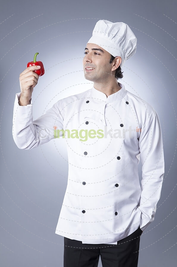 chef posing with red capsicum