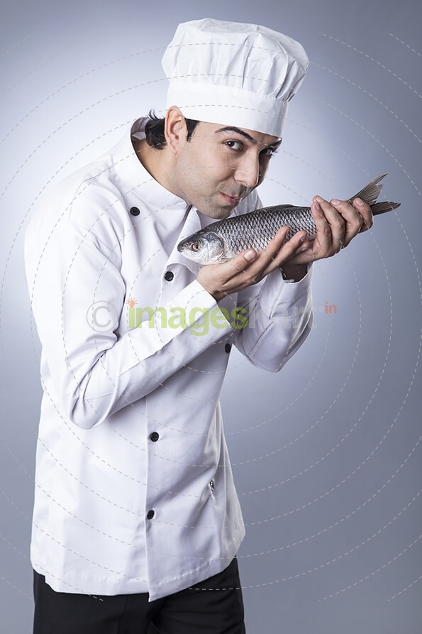 chef posing with fish 