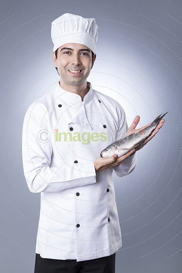 chef posing with fish 