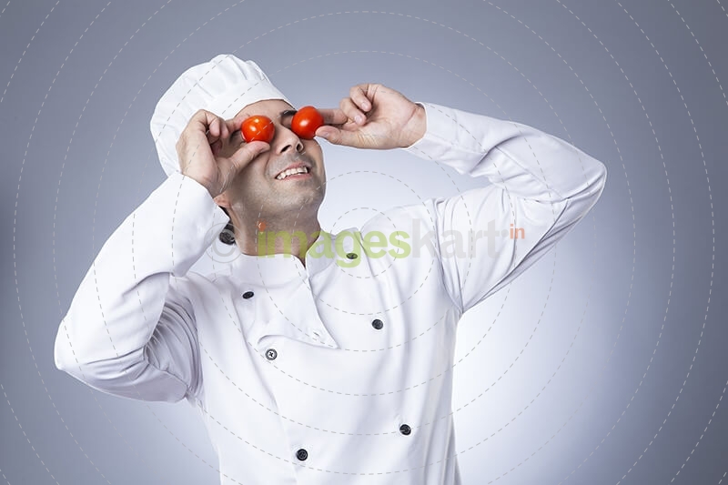 indian chef posing with tomatoes