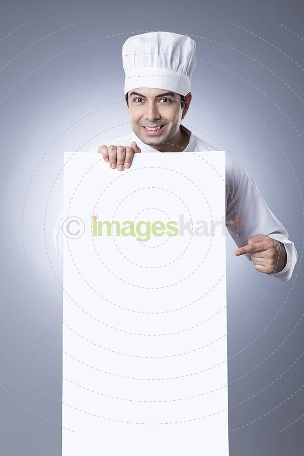 chef pointiing at placard