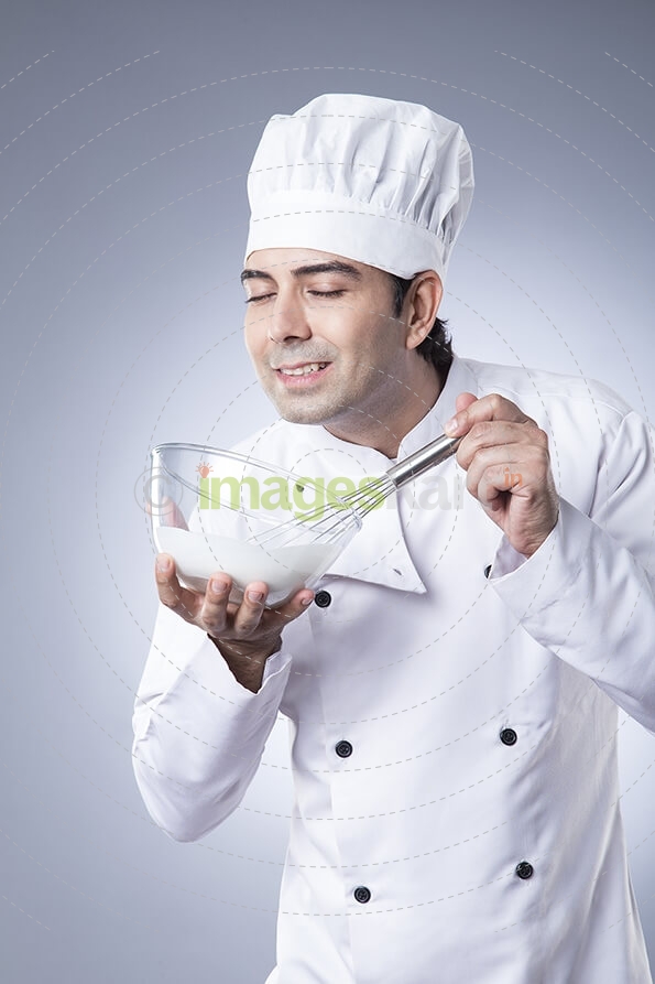 chef churning with egg beater