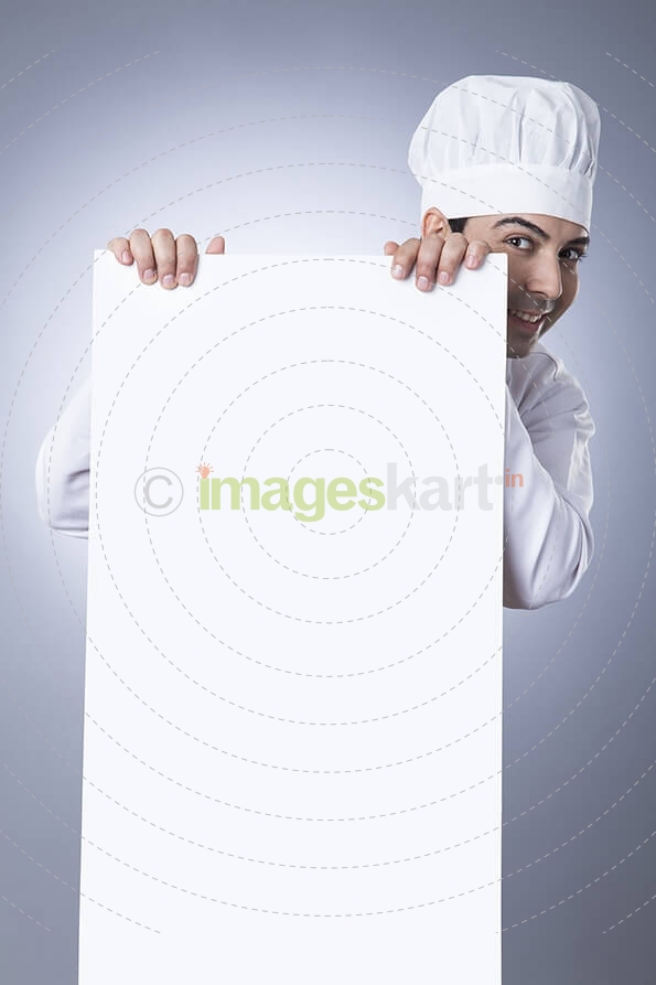 chef posing with placard