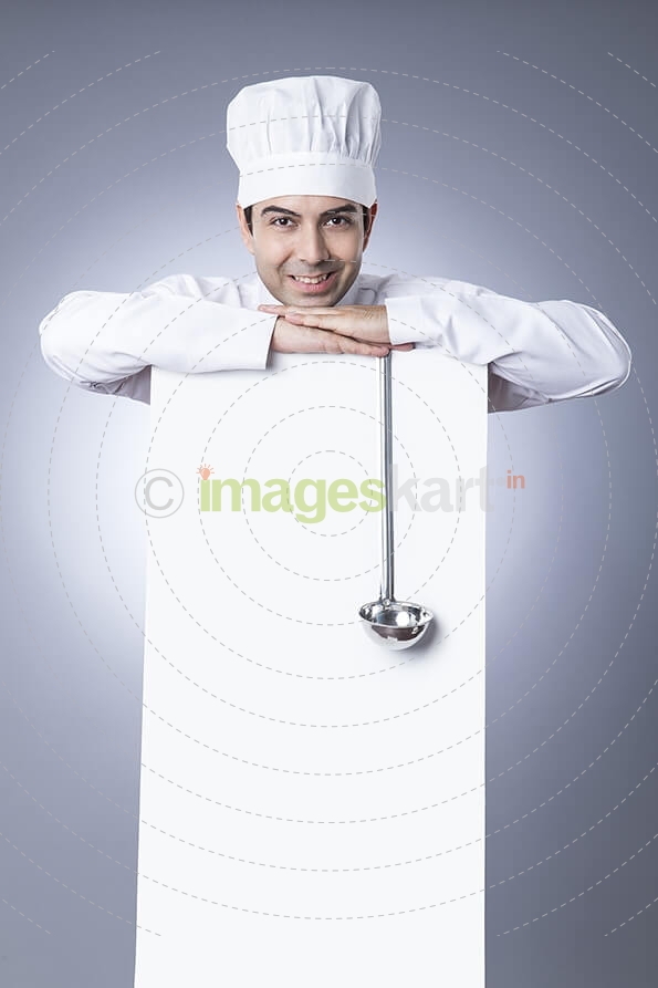 chef posing with placard