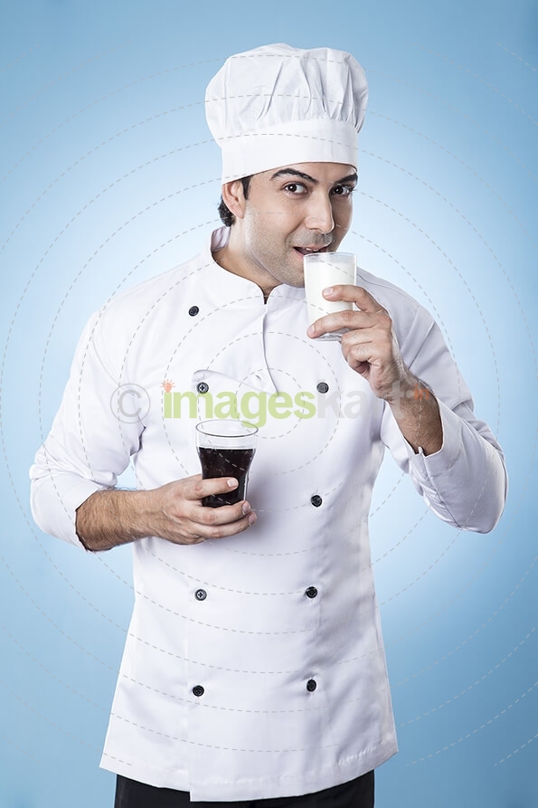 chef posing with glass of milk and soft drink