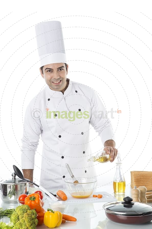 chef adding oil to the bowl 