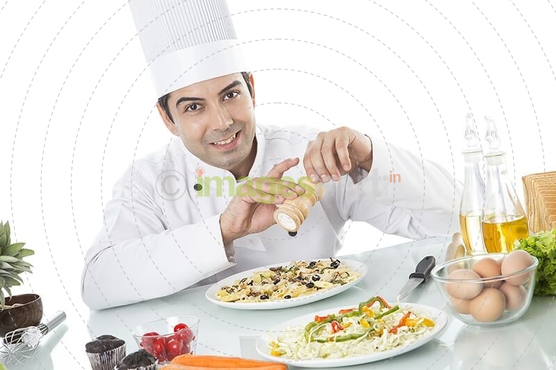 chef adding ingredient 