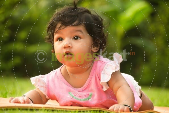 cute little girl lying on park
