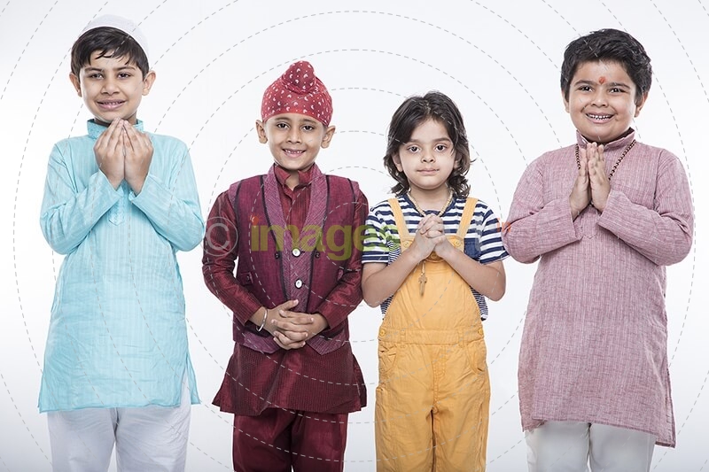 kids from different religions praying with folded hands