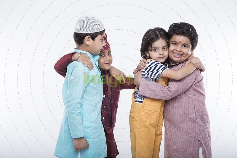 kids from different religions hugging each other 