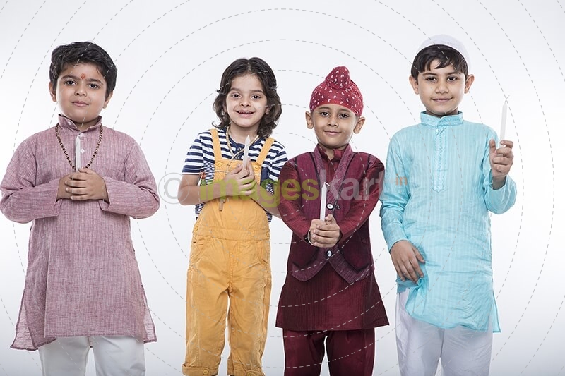 kids from different religion praying with candles
