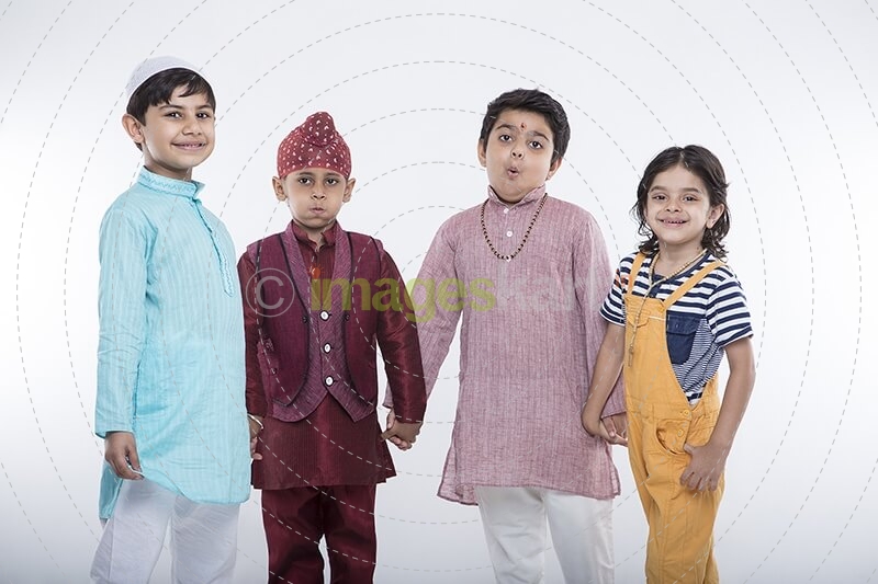 kids from different religions holding each others hands 