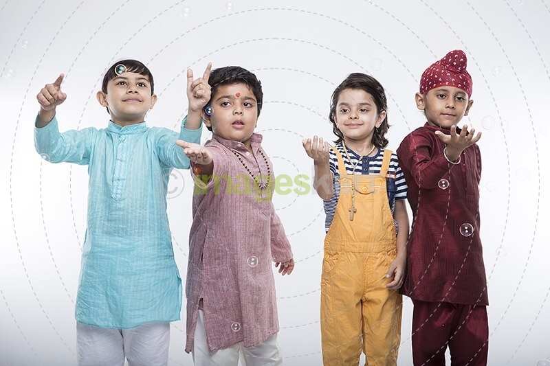 four kids from different religion playing with bubbles
