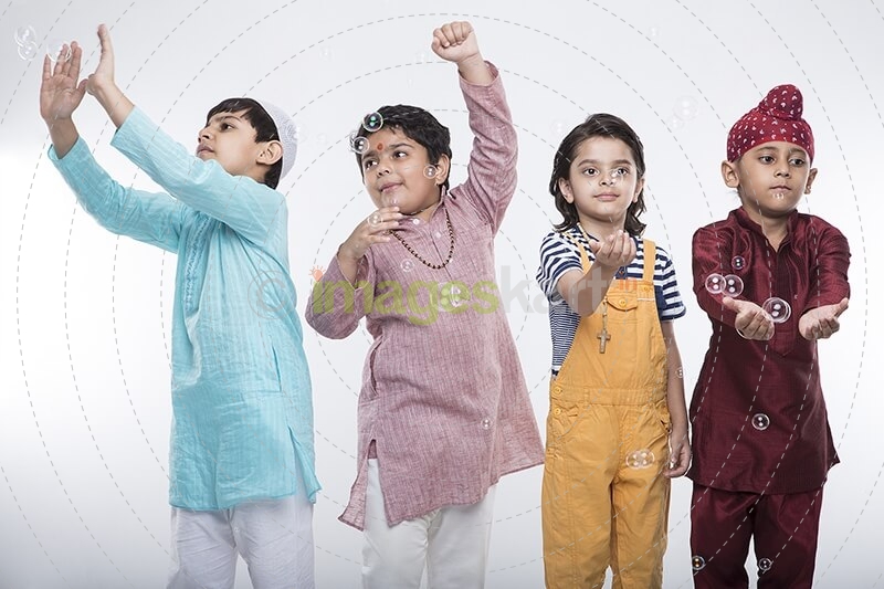 four kids from different religion playing with bubbles