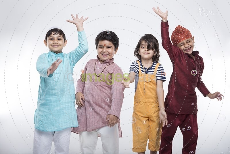 four kids from different religion playing with bubbles