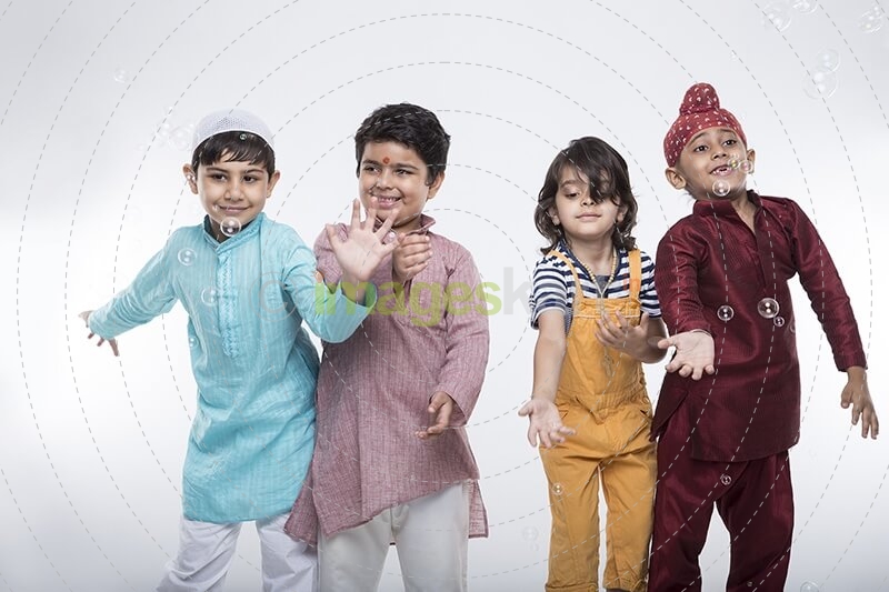 four kids from different religion playing with bubbles