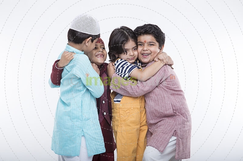 kids from different religions hugging each other 