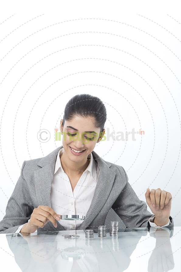woman in formals checking money with magnifying glass