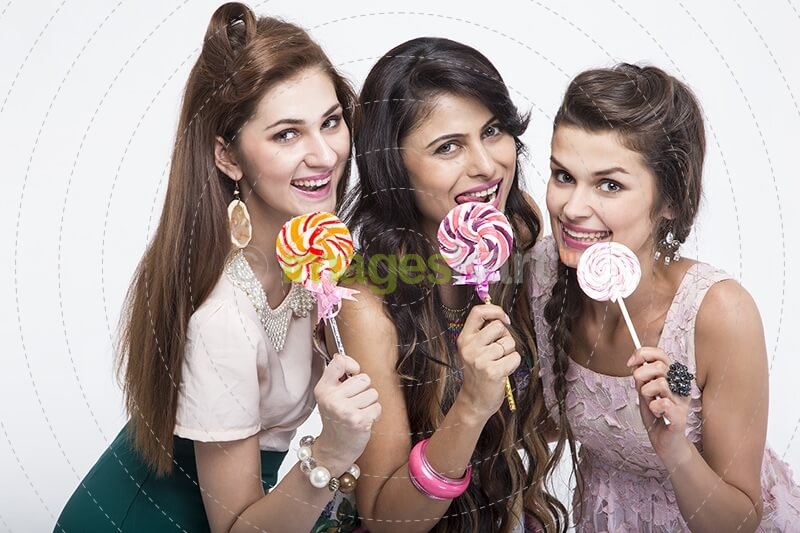 stylish girls eating candies 