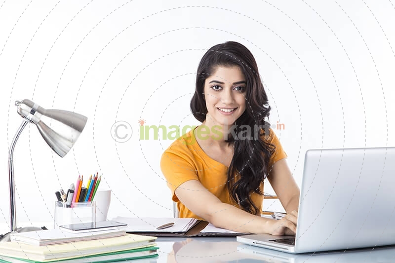 woman sitting and working on laptop 