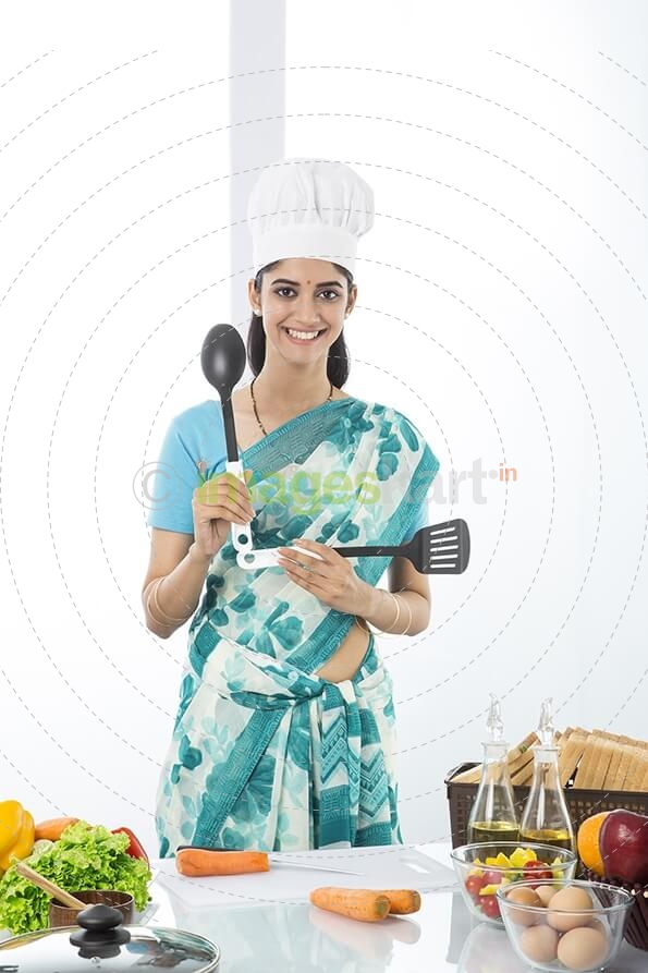 Indian housewife posing with spatula and ladle