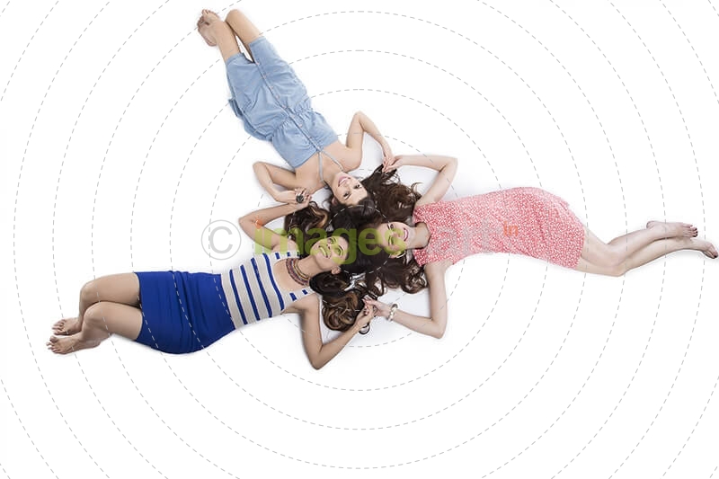 three girls lying on floor and posing