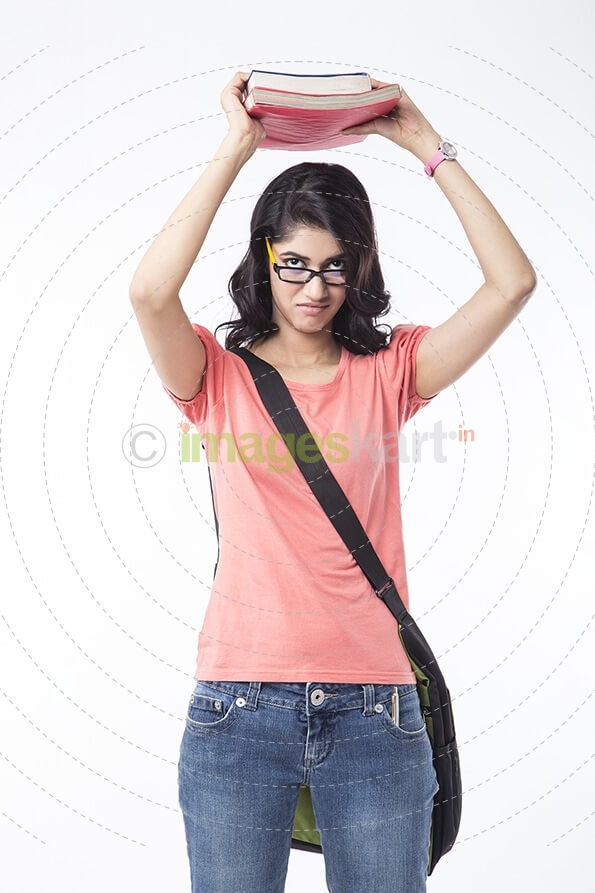 college girl posing with text books 