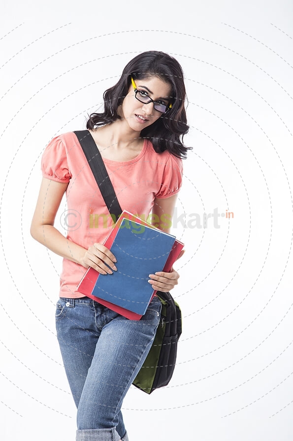 college girl holding text books and posing