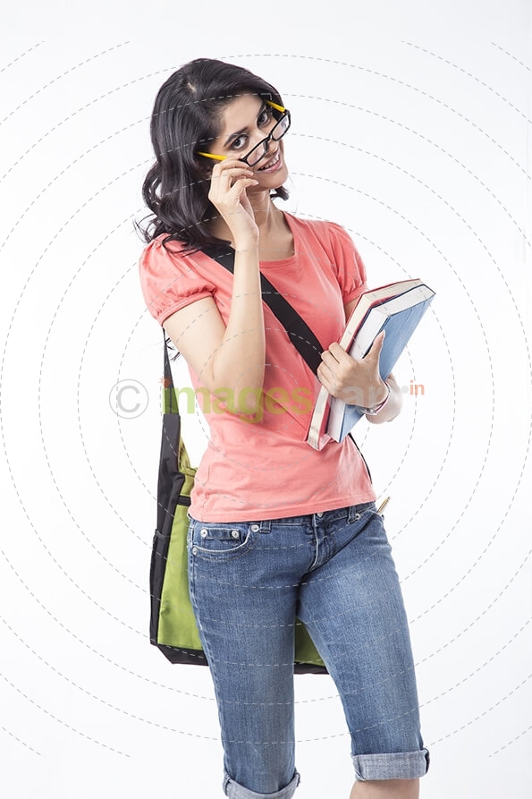 college girl holding text books and posing
