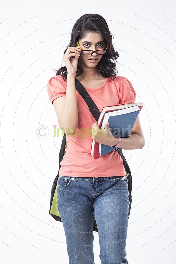 college girl holding text books and posing