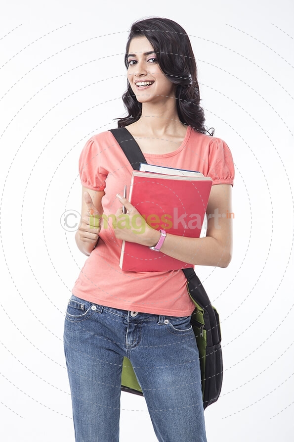 college girl holding text books and posing