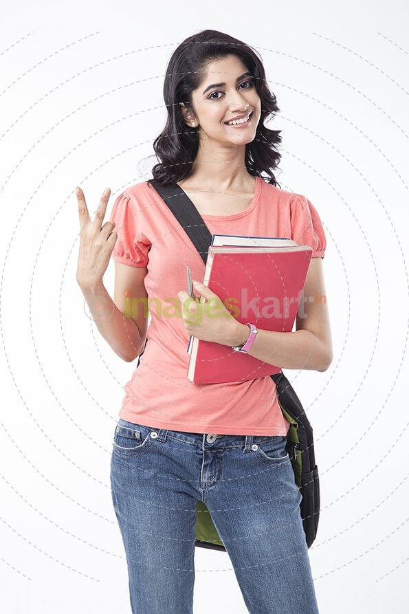 college girl holding text books and posing