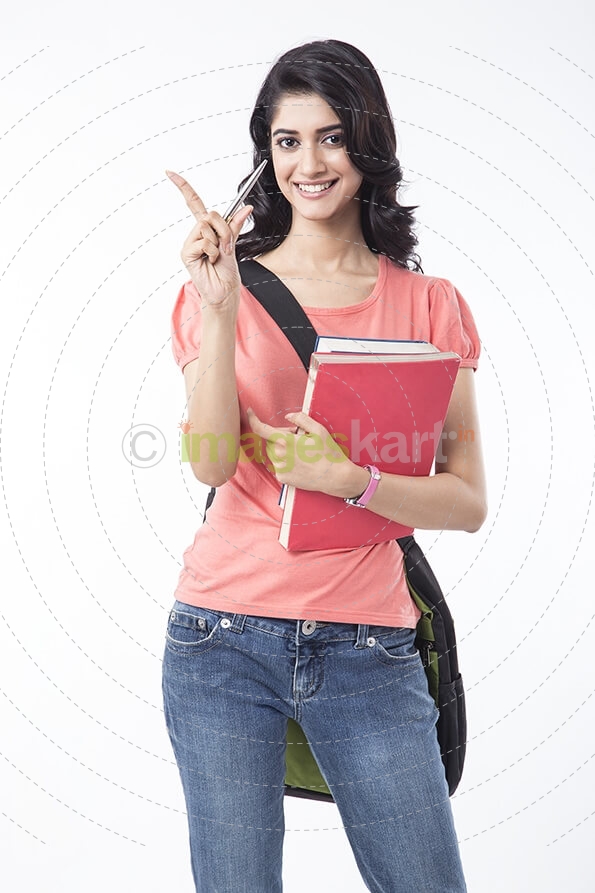 college girl holding text books and posing