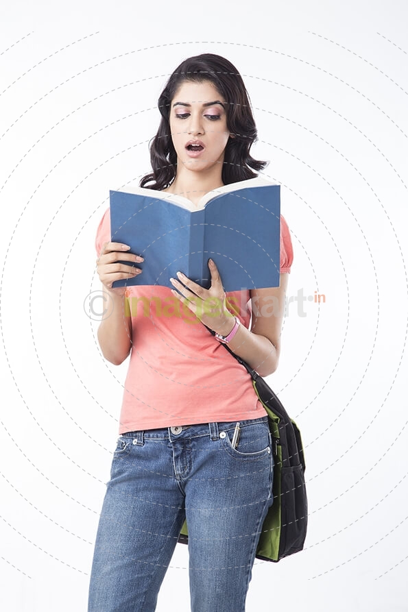 college girl posing while holding a text book