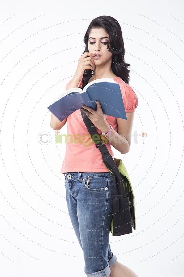 college girl posing while holding a text book