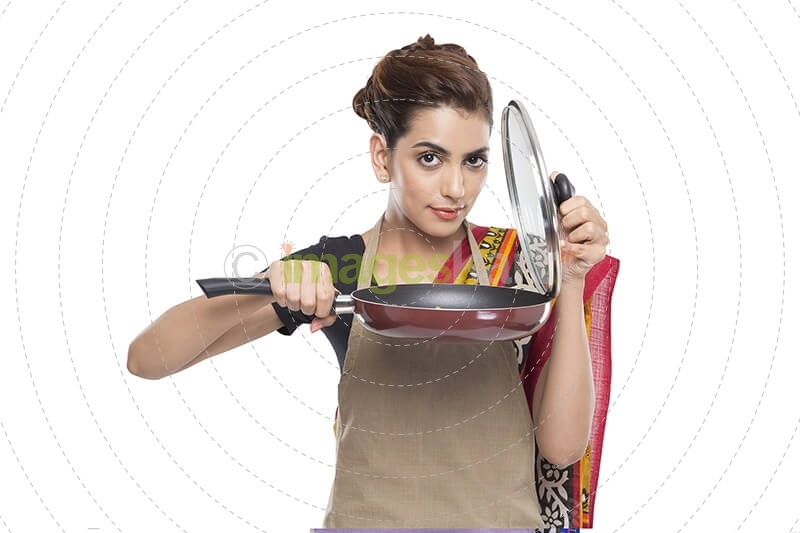 women wearing apron with fry pan